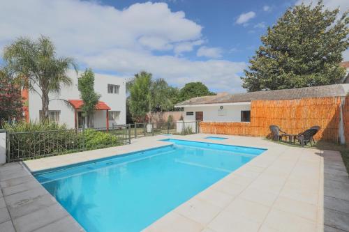 a swimming pool in the backyard of a house at Posada D`Lua in Villa Carlos Paz