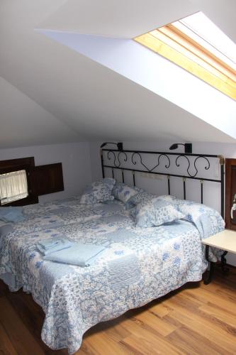 a bedroom with a bed in a room with a window at La Cantina del Tobero in Fuentetoba