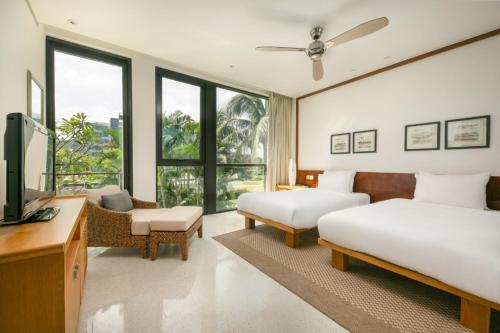 Ένα ή περισσότερα κρεβάτια σε δωμάτιο στο Abogo Hayatt Resort Beach Da Nang