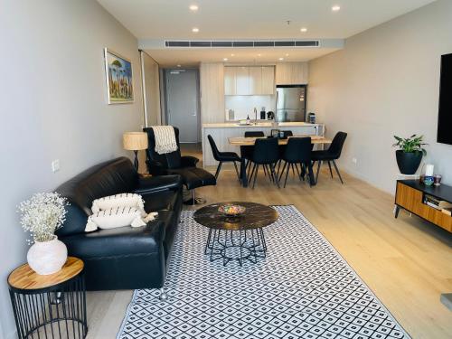 a living room with a couch and a table at Unit in Belconnen sleep up to 4 - 2Brm, 2 Bath in Belconnen