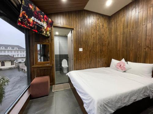 Ένα ή περισσότερα κρεβάτια σε δωμάτιο στο Căn hộ Đà Lạt Cảnh