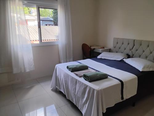 un dormitorio con una cama con dos almohadas. en UNIJUI, en Ijuí