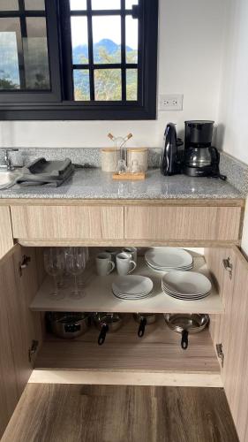 a kitchen with a counter top with plates and dishes at Villa Cinco Boquete in Alto Boquete