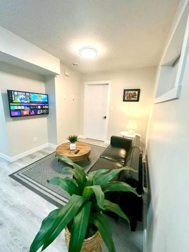 a living room with a couch and a table at Cozy guest house in Regina