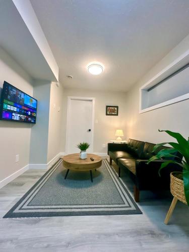a living room with a couch and a table at Cozy guest house in Regina