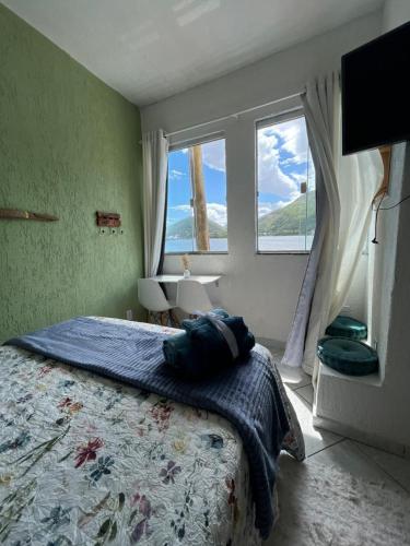 a bedroom with a large bed and a window at Sobradinho da Lagoa in Niterói
