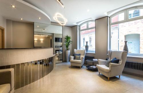 a waiting room with chairs and a mirror at Mansio Suites Basinghall in Leeds