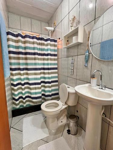 a bathroom with a toilet and a sink at Sobradinho da Lagoa in Niterói