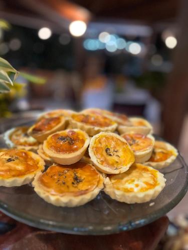 a plate of food with pies on a table at Hotel Karapitangui in Morro de São Paulo