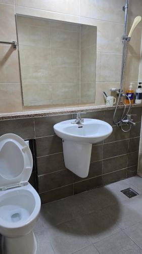 a bathroom with a toilet and a sink at Sky Motel in Gumi