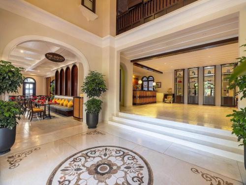 an empty lobby with a table and chairs in a building at Little Residence - A Boutique Hotel & Spa in Hoi An