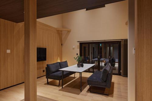 a dining room with a table and two chairs at SUITE VILLA 惺 - shou - in Takashima