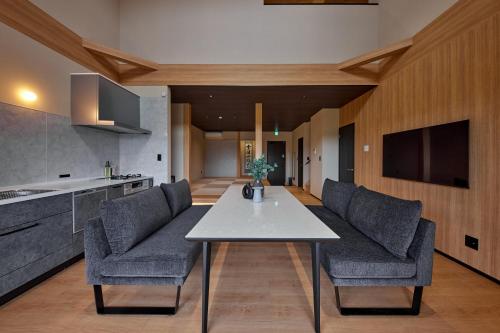 a kitchen and dining room with a table and chairs at SUITE VILLA 惺 - shou - in Takashima