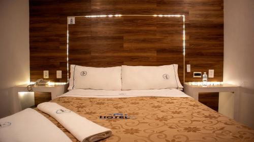 a bedroom with a large bed with two night stands at Hotel Muy Cdmx, Love Hotel in Mexico City