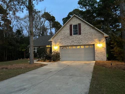 a house with a garage with lights on it at Royal Pines in New Bern