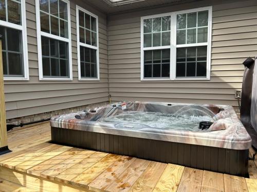 a hot tub sitting outside of a house at Royal Pines in New Bern