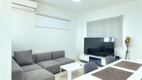 a living room with a couch and a tv at 嘉翔の家 in Otsu