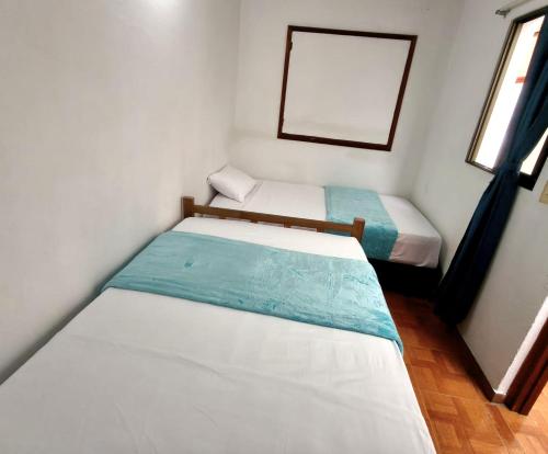 Postel nebo postele na pokoji v ubytování Roomiie Hostel