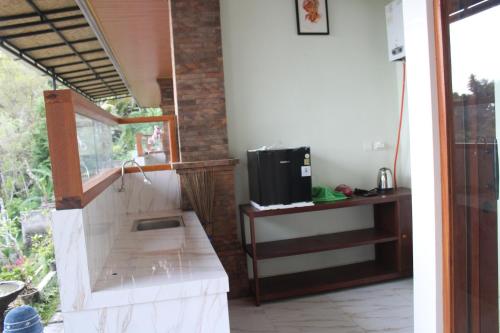 een kamer met een tv aan de muur bij Rumah Bagus Jayanti in Sidemen