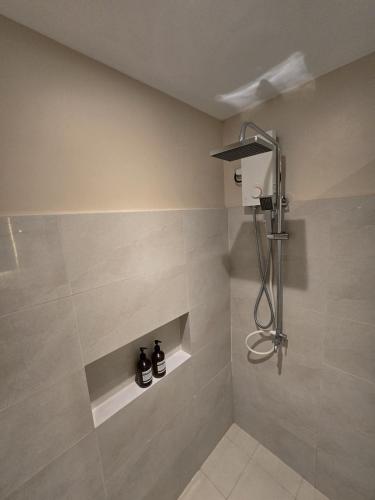 a bathroom with a shower with two shoes at Kāpena Siargao in General Luna