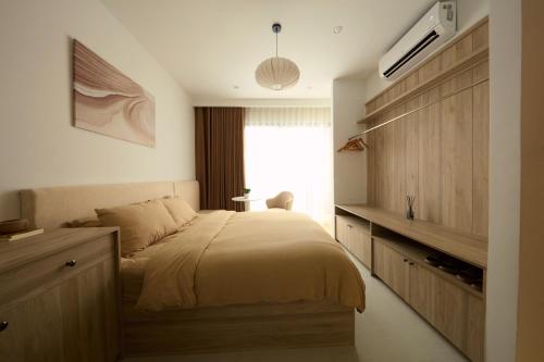 a bedroom with a large bed and a window at Lens Stay in Ho Chi Minh City