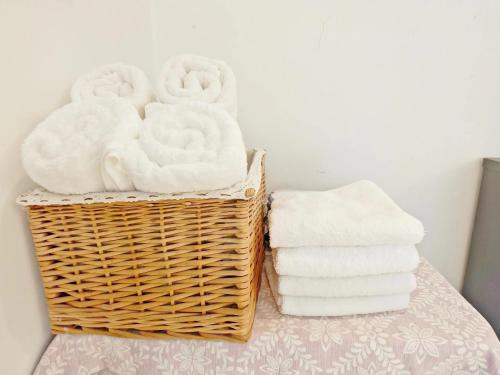 a basket of towels sitting next to a stack of towels at A&G Apartment in Zhangjiajie
