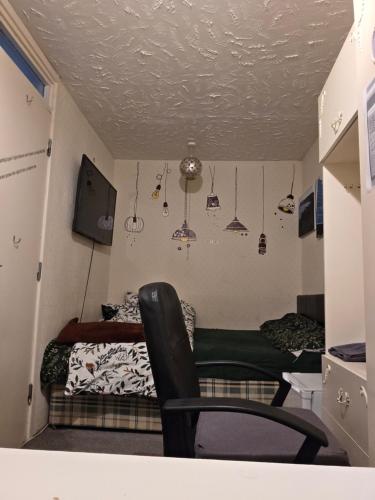 a room with a bed and a chair in it at Private Room in Amley