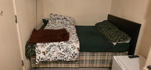 a bed in a room with two pillows on it at Private Room in Amley