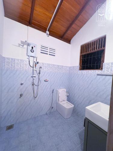 a bathroom with a shower and a toilet in it at Villas by DIMA in Galle