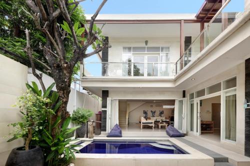 a house with a pool in the middle of a courtyard at Villa Alba in Seminyak