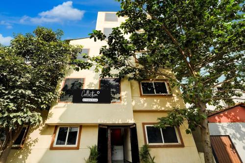 a building with a sign on the side of it at Collection O Kammasandra Gate Bus Terminal Formerly Riches Inn in Bayappanhalli