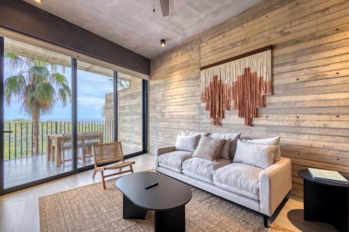 a living room with a couch and a table at OR Cabo Boutique Residences by Lumina in Cabo San Lucas