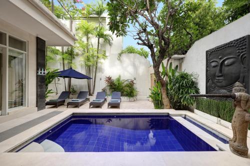 a swimming pool in the backyard of a house at Villa Alba in Seminyak