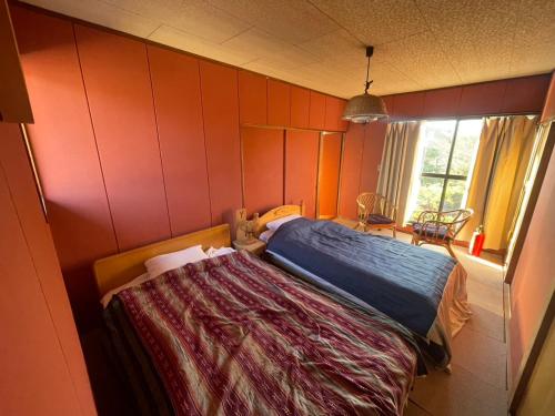 Ένα ή περισσότερα κρεβάτια σε δωμάτιο στο 和の家 縁en 白馬へアクセス良好