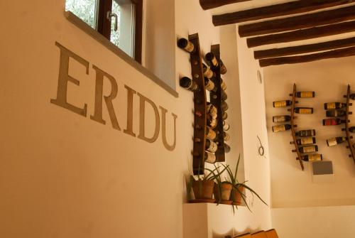 a room with a wall filled with wine bottles at B&B Eridu in Fiesole