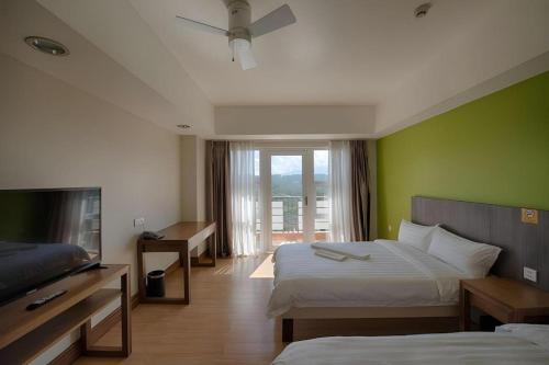 Ένα ή περισσότερα κρεβάτια σε δωμάτιο στο Newtown Plaza Hotel