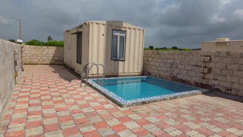 a small swimming pool in front of a building at Aqua Dream Water Park in Bhuj