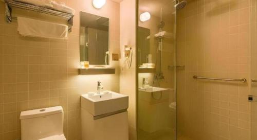 a bathroom with a toilet and a sink and a shower at Jinjiang Inn Select Xuzhou High-speed Railway Station Kunpeng Road in Xuzhou