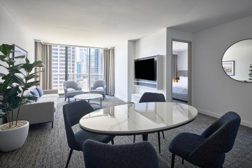 a hotel room with a table and chairs at Meriton Suites Pitt Street, Sydney in Sydney