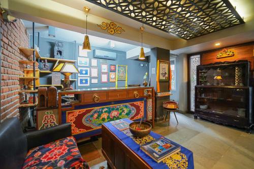 a living room with a couch and a fireplace at Open Hotel by Olive - Utse Suites in Bengaluru