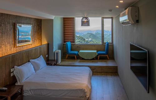 Ένα ή περισσότερα κρεβάτια σε δωμάτιο στο Jiufen HappyLand B&B