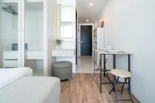 a small apartment with a bed and a table and a kitchen at Studio Apt Seaview Balcony - Oceana C63 in Kamala Beach