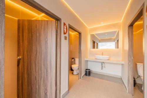 a bathroom with a toilet and a sink at The All New Stark Boutique Hotel in Kuta