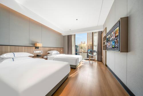 Ένα ή περισσότερα κρεβάτια σε δωμάτιο στο Yangji Yueya Hotel