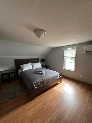a bedroom with a bed in a room with a window at Private Room Lakeview House- Westmount in Moncton
