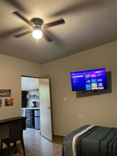 a bedroom with a ceiling fan and a television on the wall at LiV109 Norte Depa 8 Cd Obregon in Ciudad Obregón
