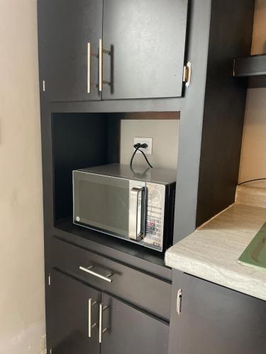 a kitchen with a microwave on top of a counter at LiV109 Norte Depa 8 Cd Obregon in Ciudad Obregón