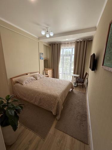 Una cama o camas en una habitación de Апартаменты в Чайка Резорт, Иссык-Куль