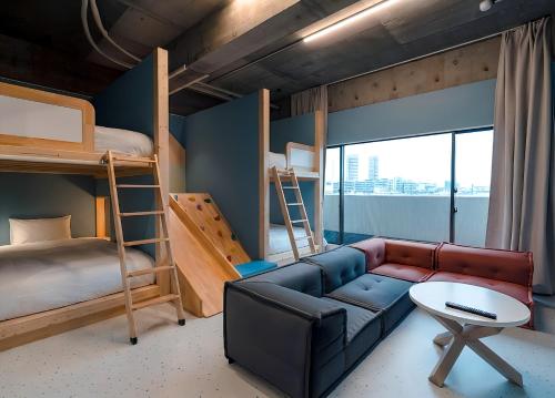 a living room with a couch and bunk beds at Visionary Stay HINODE in Tokyo
