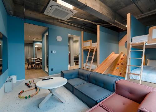a living room with a couch and bunk beds at Visionary Stay HINODE in Tokyo
